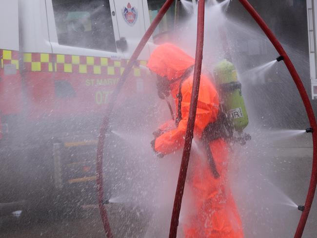 This is St Marys Fire and Rescue D platoon senior firefighter Tim Lloyd in the decontamination shower at the station. Picture: Danielle Jarvis