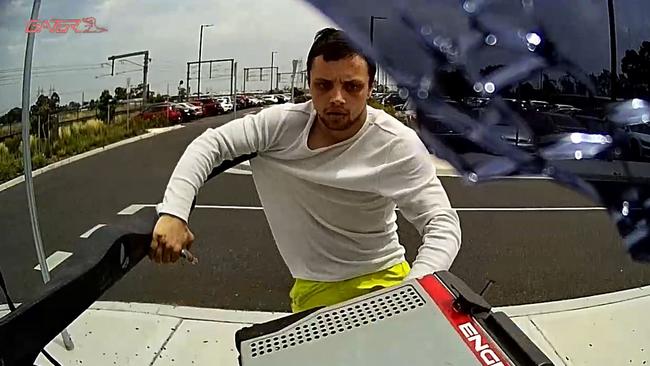 Dashcam captures a man stealing a car fridge and smashing up a ute parked at Middle Gorge train station in South Morang.