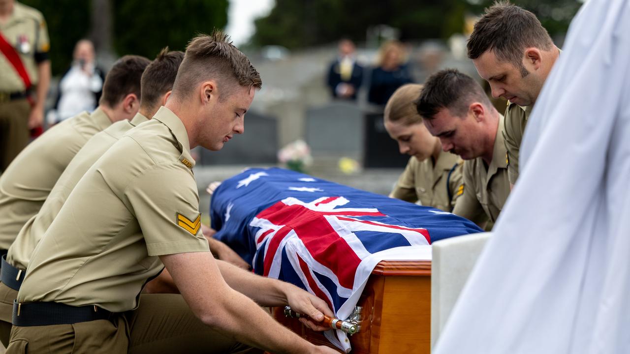 Australian Army soldier Corporal Caleb Blenkhorn from 12th/40th Battalion, Royal Tasmania Regiment, prepares to lower the coffin of one of the World War I veterans being reinterred at Cornelian Bay Cemetery in Hobart on Thursday, 06 March 2025. Picture: Corporal Michael Currie