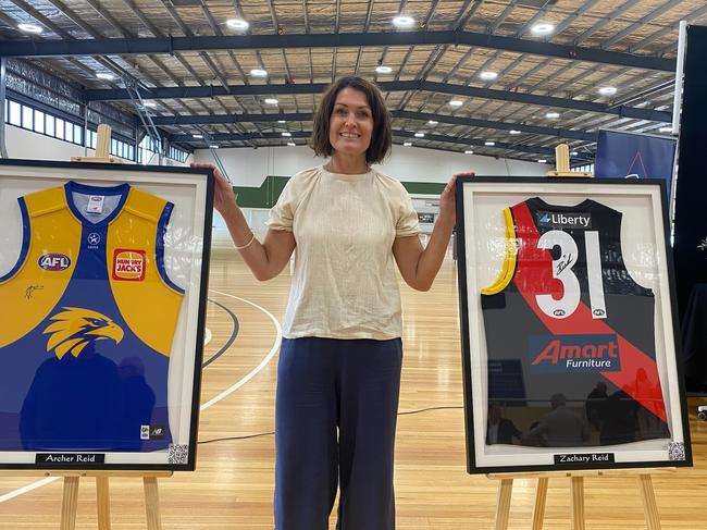 Megan Reid with the AFL jumpers of her sons, Archer and Zac.