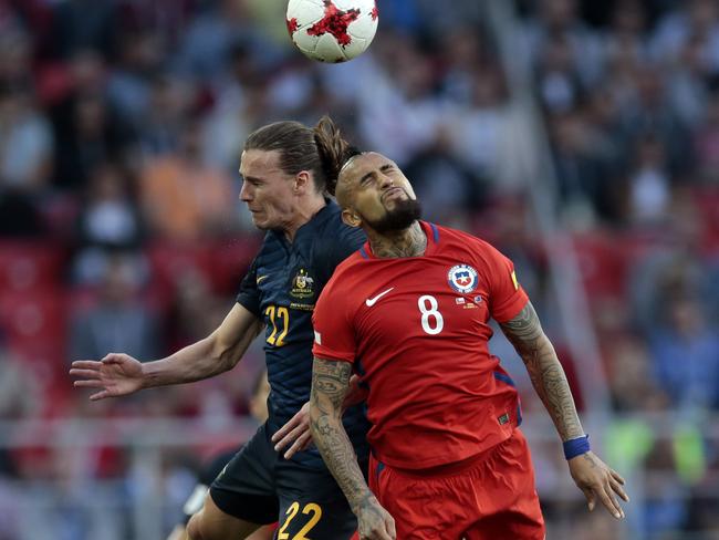 Jackson Irvine tries to get the better of Arturo Vidal.