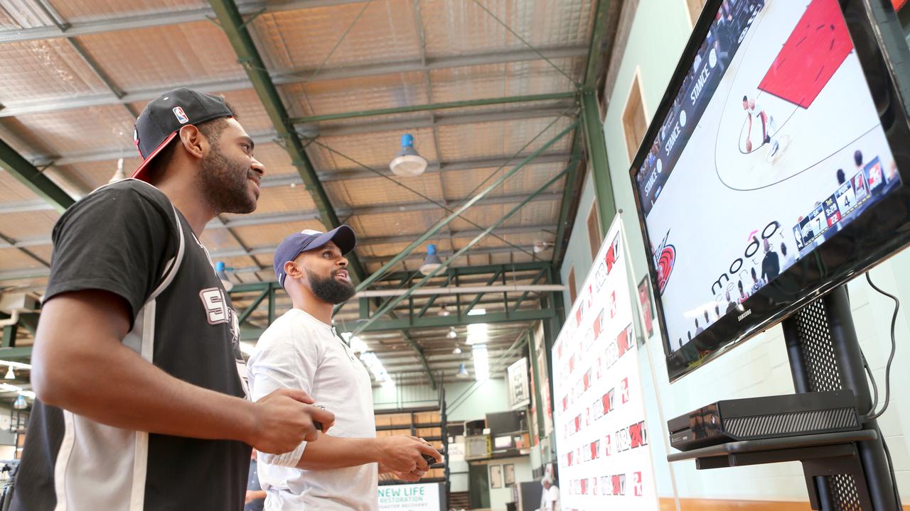 NBA star Patty Mills playing NBA 2K. Photo: Jono Searle.