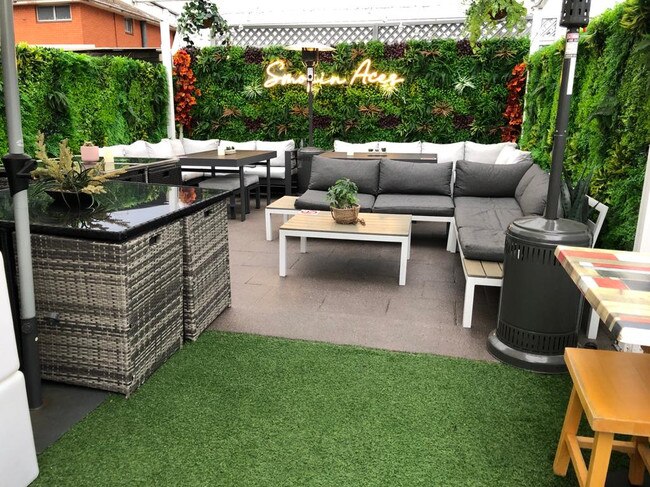 Outdoor of Smokin Aces, compete with faux grass and seating