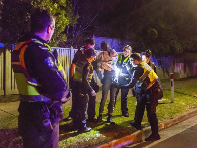 Officers search the youth. Picture: Valeriu Campan