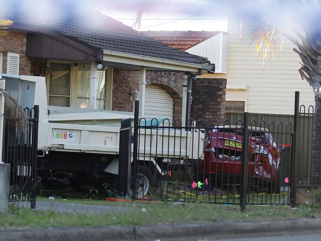 A mangled car on the front yard where the truck crashed through. Picture: Danny Aarons