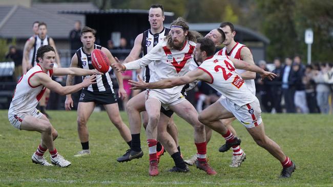 OEFL: Olinda Ferny Creek’s Chris Darling and Kelsey Currie reach for the ball. Picture: Valeriu Campan