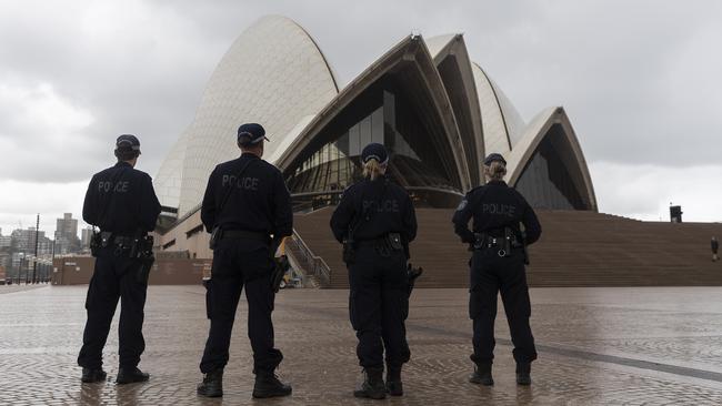 Police look over a near-empty Sydney Opera House forecourt on New Year’s Eve. Picture: Brook Mitchell/Getty Images