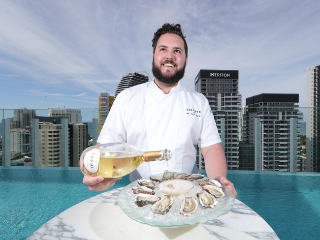 Nineteen at The Star executive chef Kelvin Andrews with champagne and oysters up at the rooftop venue prepping for Friday's first birthday. Picture Glenn Hampson