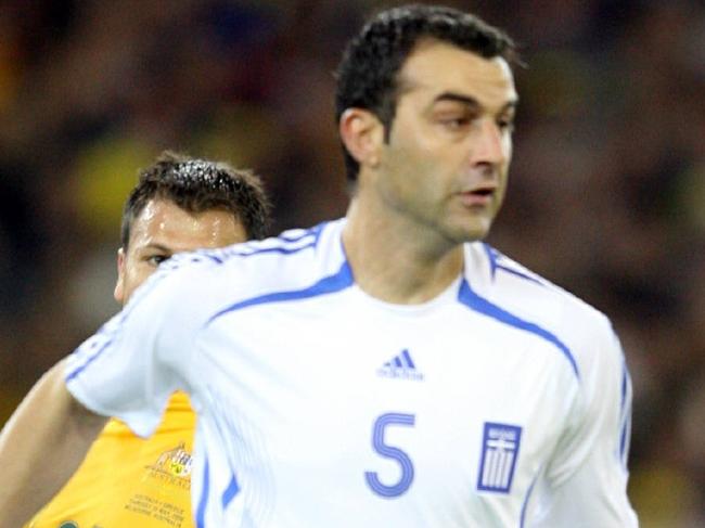 Australia v Greece Soccer. MCG. Greece's Traianos Dellas in front of Mile Sterjovski