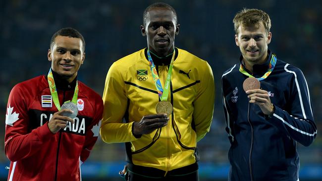 Andre De Grasse with his silver medal in the 200m at the Olympics with Usain Bolt. Picture: Getty Images