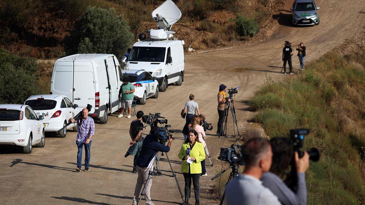 Journalists are seen as Portuguese Judicial Police (PJ) criminal investigation unit members work in the Arade dam are. Picture: Filipe Amorim/AFP