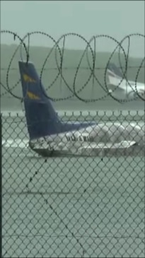 Floods submerge planes on Cairns Airport runway