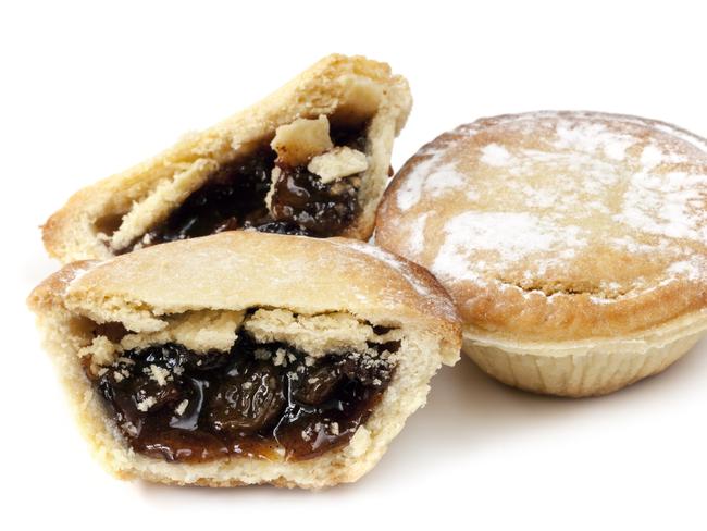 Two mince pies, isolated on white background.  One whole and the other cut.  Traditional Christmas fare.