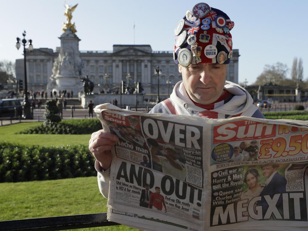 Self-proclaimed royal super-fan John Loughrey digests the news in front of Buckingham Palace Picture: AP Photo/Kirsty Wigglesworth.
