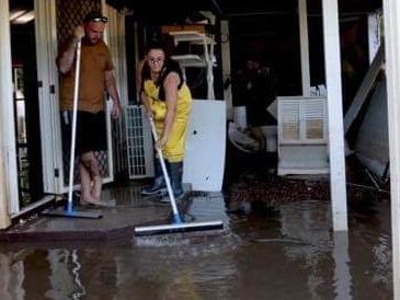 Queen St residents Courtney Azzopardi, Jay Waters and his mother Chris spent two days constructing a levee around their home.