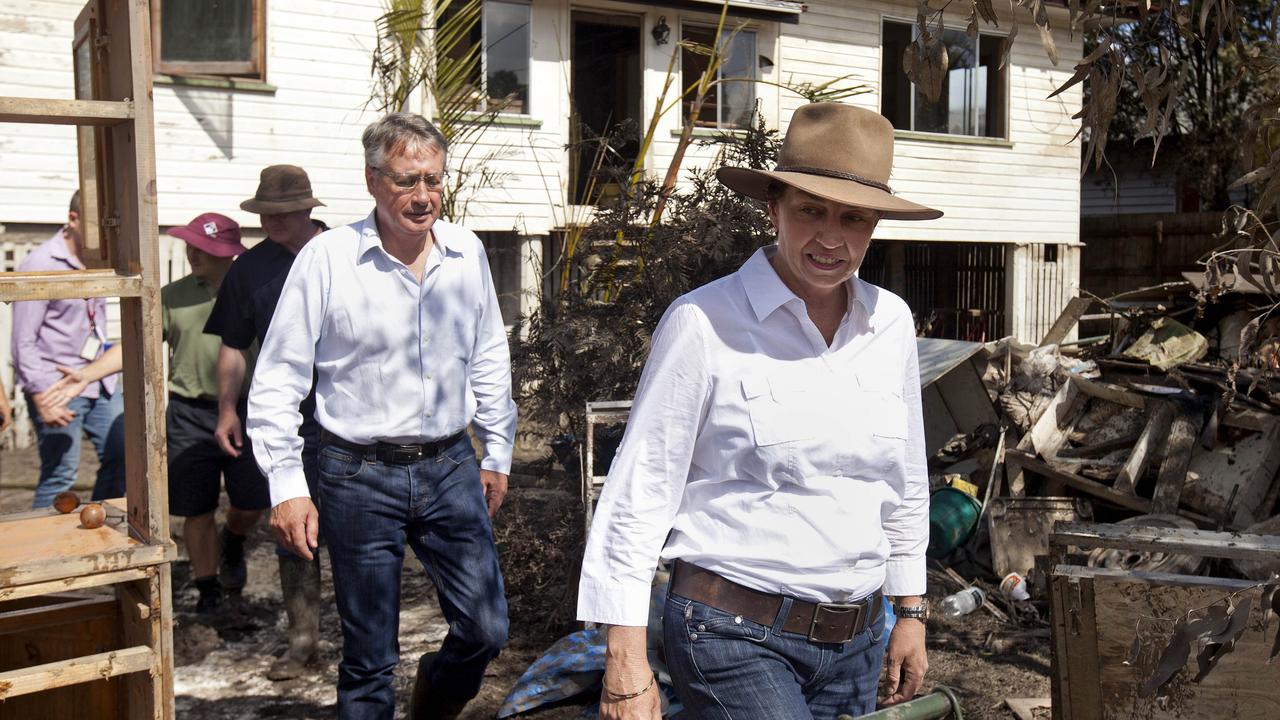 The federal treasurer Wayne Swan and premier Anna Bligh survey the damage along a street in Brisbane on January 1, 2011.