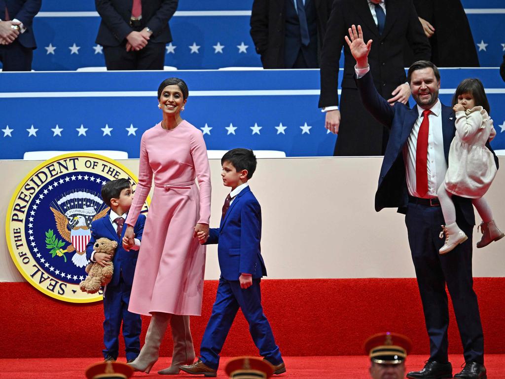 US Vice President JD Vance (R), US Second Lady Usha Vance and their children walk on stage as they arrive the inaugural parade inside Capital One Arena.