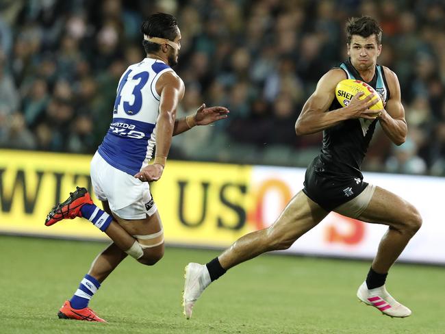 Ryan Burton evades North Melbourne’s Aaron Hall earlier in the season. Picture: Sarah Reed