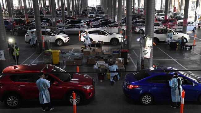 Medical workers staff a drive-through COVID-19 testing site located in a shopping centre carpark in Melbourne. Picture: AFP