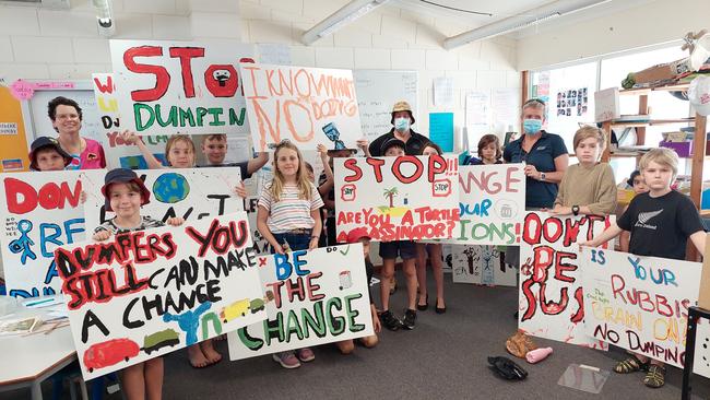 Enkindle Village School students show off their hand painted signs that will feature at rubbish dumping sites. Picture: Leighton Smith