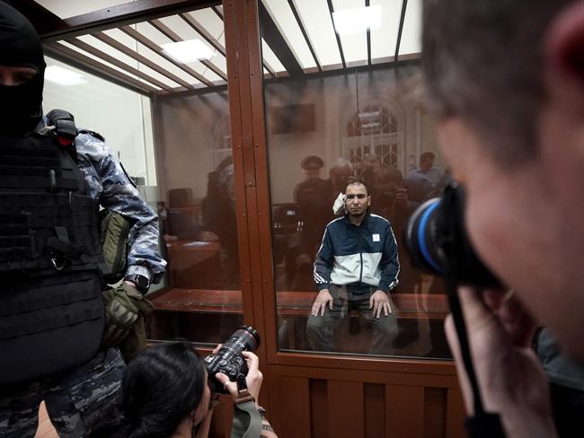 A concert hall attack suspect behind glass in court. Picture: AFP