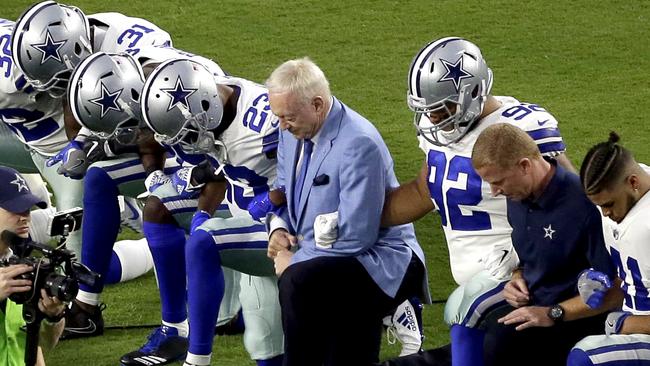 The Dallas Cowboys, led by owner Jerry Jones, centre, take a knee prior to the national anthem before their Monday Night Football game against the Arizona Cardinals. Picture: AP