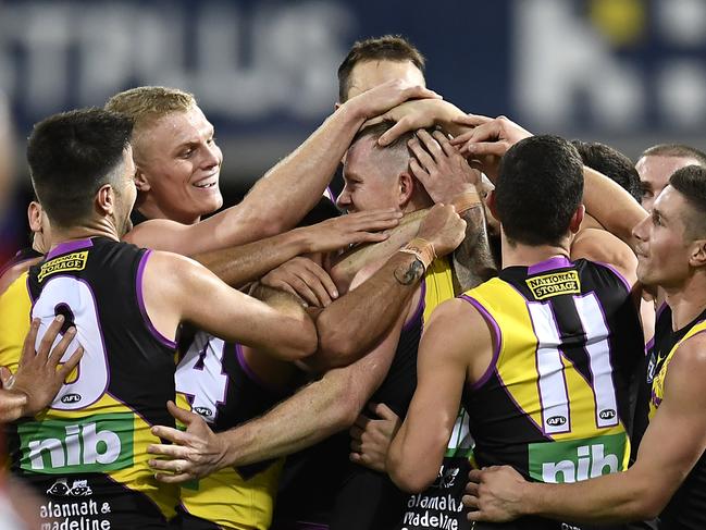 GOLD COAST, AUSTRALIA - JULY 16: Jack Riewoldt of the Tigers celebrates with team mates after kicking the last goal of the match during the round 18 AFL match between the Richmond Tigers and the Brisbane Lions at Metricon Stadium on July 16, 2021 in Gold Coast, Australia. (Photo by Albert Perez/AFL Photos via Getty Images)