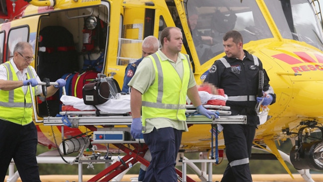 Paramedics rush a victim of the crash from helicopter to hospital.