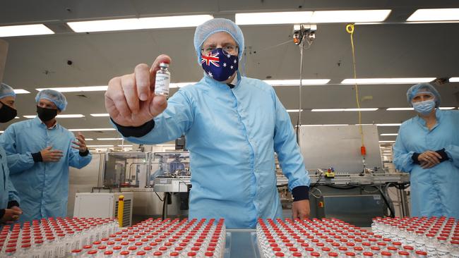 Prime Minister Scott Morrison with the Oxford-AstraZeneca, which is yet to be approved in Australia.