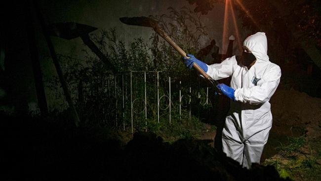 A gravedigger wears protective clothing at the Recanto da Paz Municipal Cemetery during the burial of a victim of COVID-19. Picture: AFP