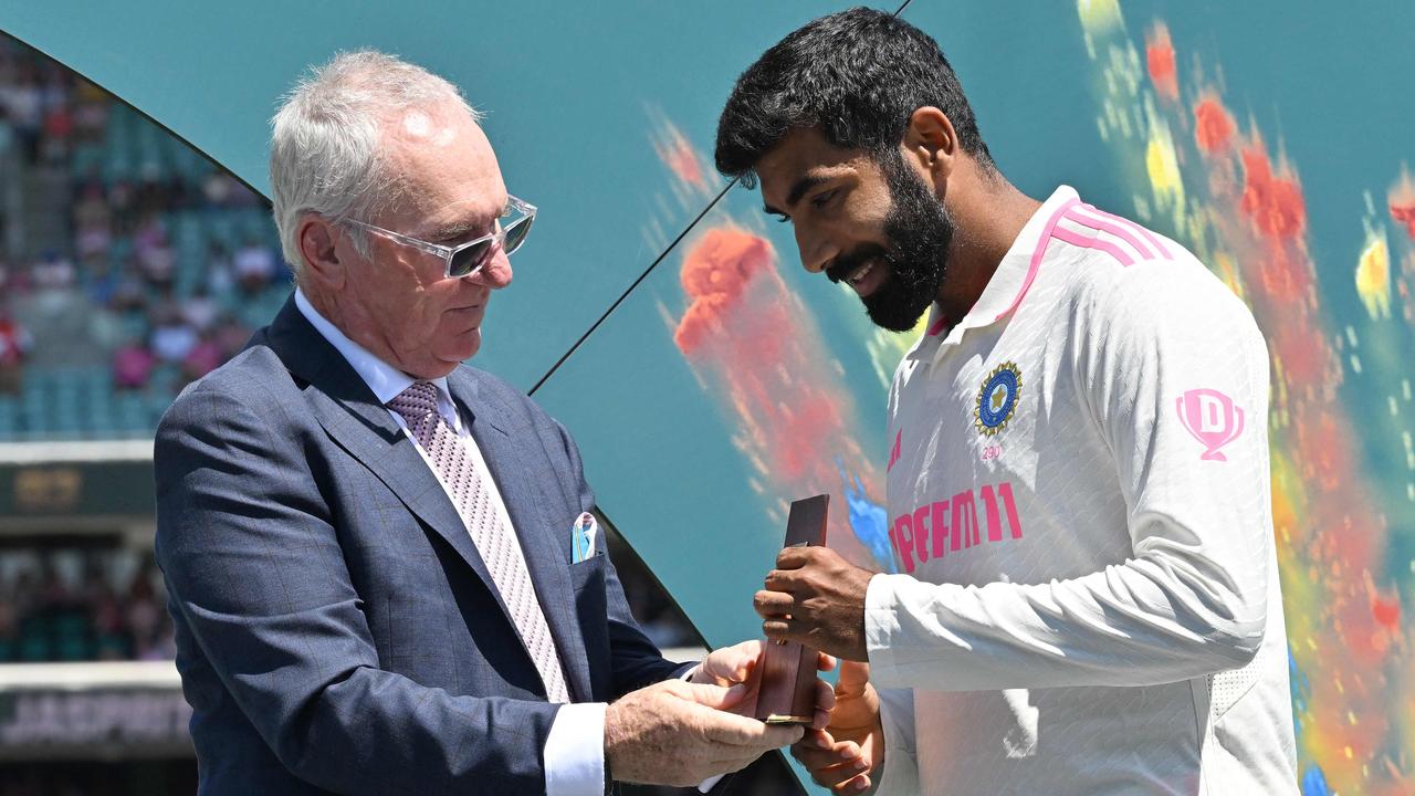 India’s Jasprit Bumrah receives the Player of the Series award from Allan Border. (Photo by Saeed KHAN / AFP)