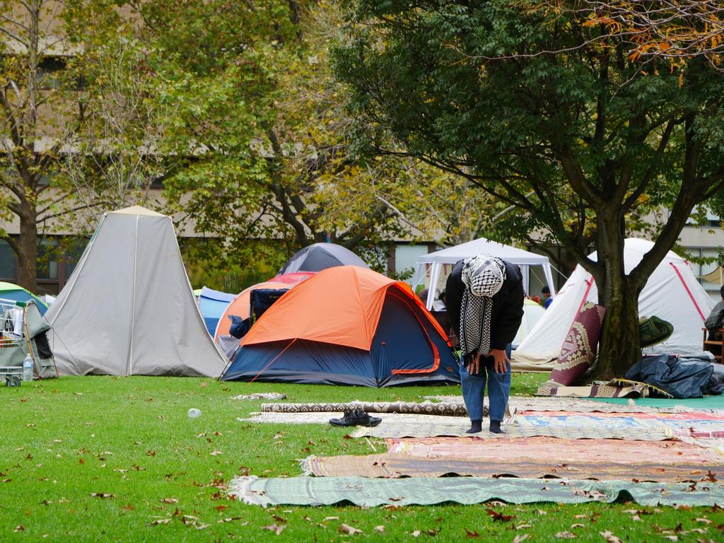 A woman prays at a University of Melbourne pro-Palestine encampment. Picture: NCA NewsWire / Blair Jackson