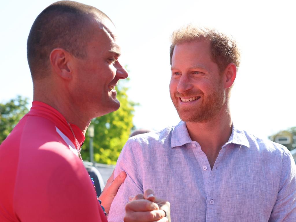 Prince Harry greets Kasper Holm Henriksen with a toothy smile at the Invictus Games before his birthday dinner. Picture: Getty Images