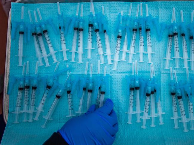 A health worker makes Moderna Covid-19 vaccines ready to be administered at a vaccination site in Los Angeles. Picture: AFP