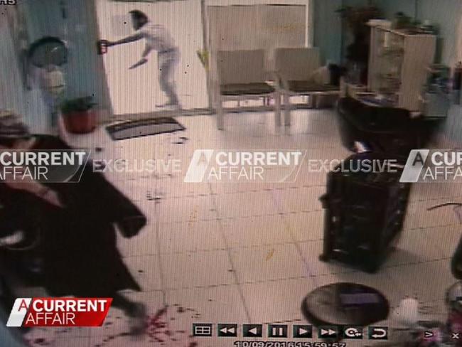 Terror suspect Ihsas Hkan, 22, is allegedly shown trying to force his way into the Minto hair salon where a badly injured Wayne Greenhalgh, whose blood can be seen in the foreground, has sought refuge. Picture: A Current Affair/Channel 9