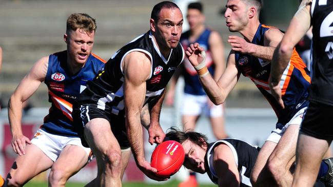 Cory McGrath fires off a handball for Moonee Valley. Picture: Jamie Morey