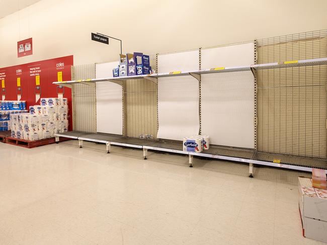 Shoppers empty supermarkets of toilet paper as lockdowns are announced. Picture: David Geraghty