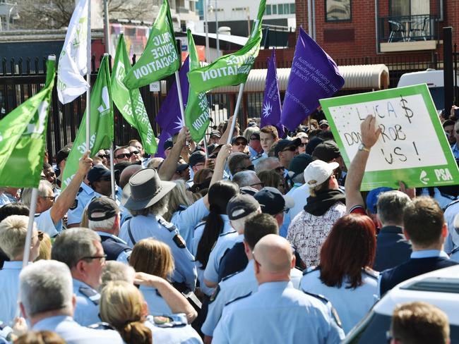 Members of the Public Service Association on their way to a rally at Parliament House in Adelaide (AAP Image/David Mariuz)