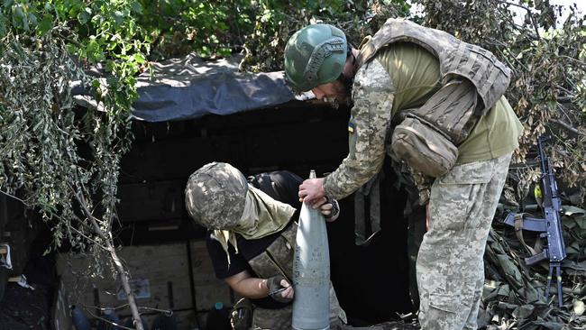 Ukrainian artillerymen prepare projectiles for artillery on the front line near Bakhmut. Picture: AFP