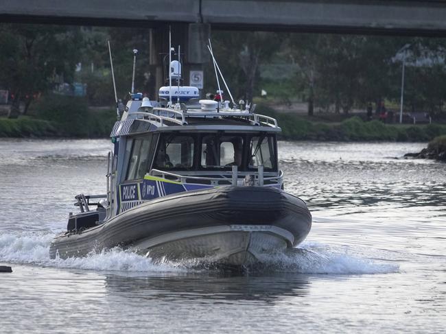 Water Police trawl the Maribyrnong River at Flemington. Picture: Valeriu Campan