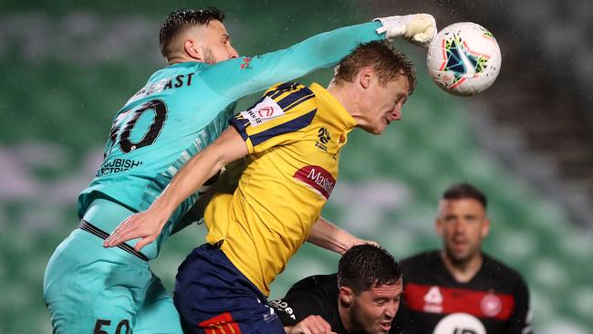 Wanderers goalkeeper Tristan Prendergast deflects the ball away from a challenge from Mariners forward Matt Simon. Picture: Getty Images