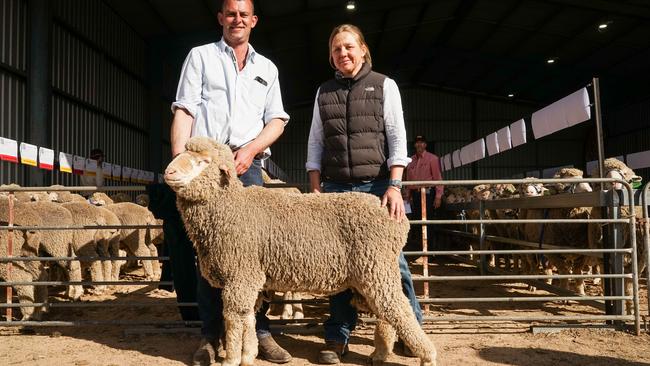 Willera Poll Merinos stud operations manager Simon Coutts and Farmers Leap livestock manager Jo Roper with the top-priced ram, Lot 113. Picture: Rachel Simmonds