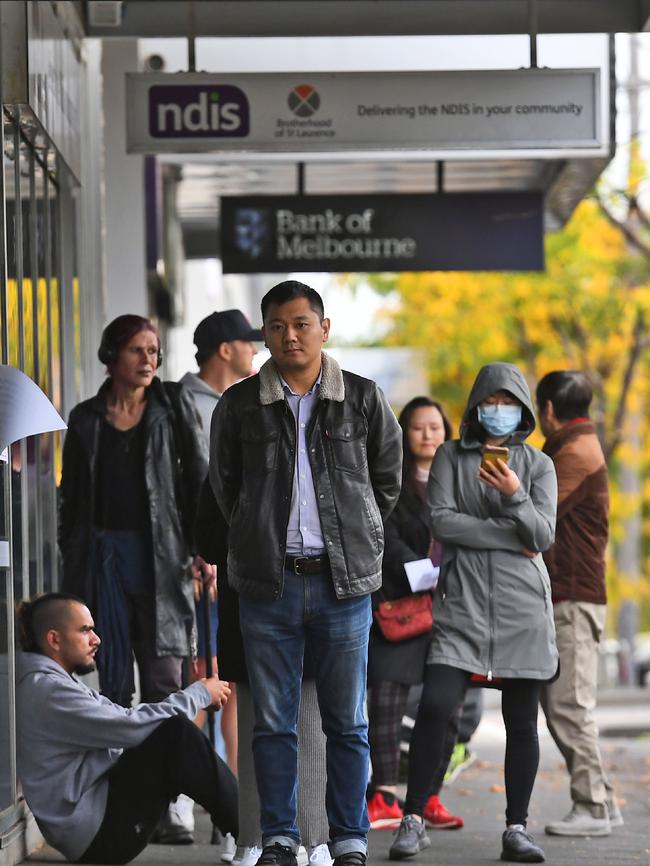 People queue up outside a Centrelink office in Melbourne on April 20.