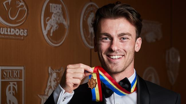 Luke Partington poses for a picture with the Magarey Medal at Adelaide Oval in North Adelaide, after receiving the honour, Monday, Sept. 9, 2019. Picture: MATT LOXTON