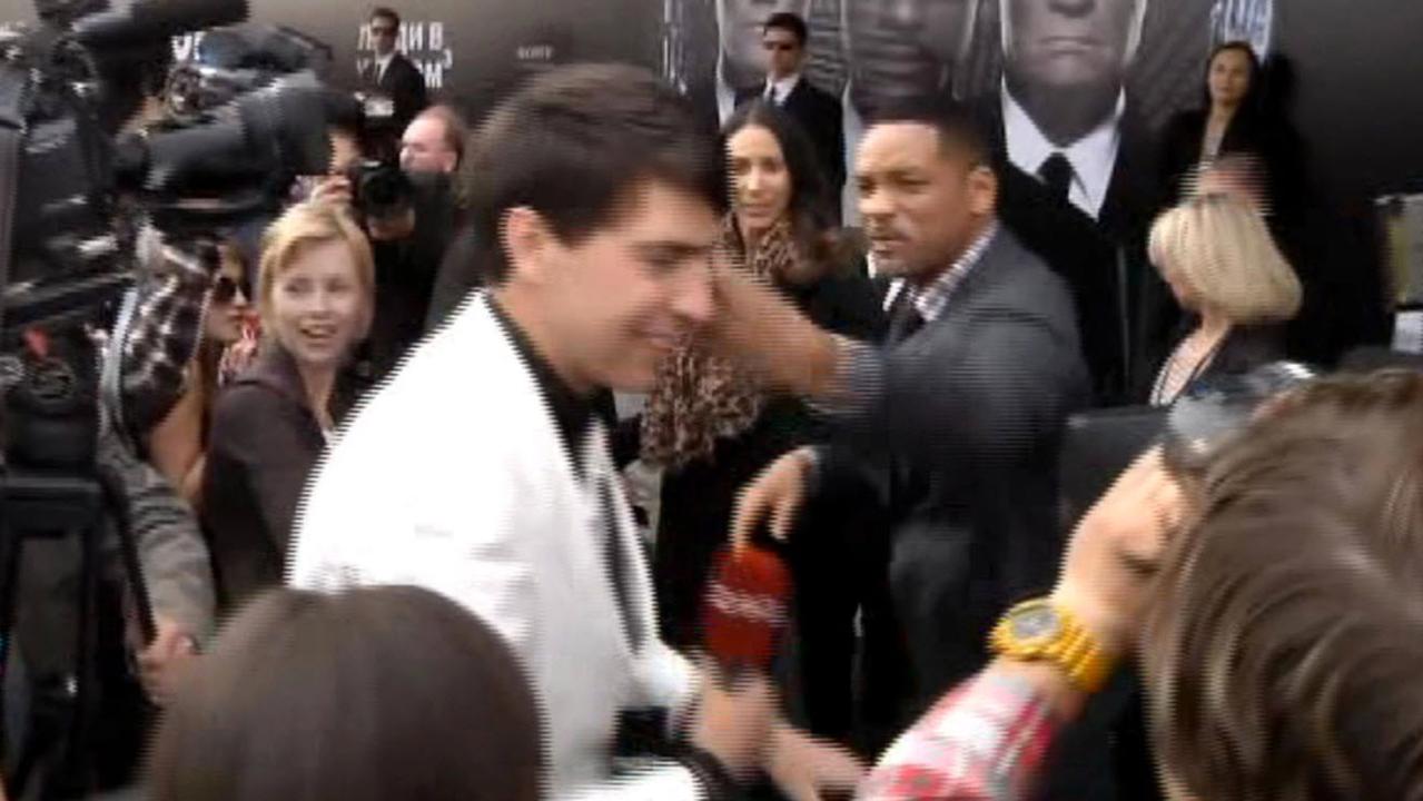 Will Smith gives a backhander to a reporter on the red carpet. Picture: YouTube