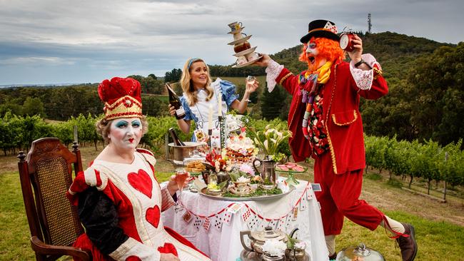 TEA PARTY: Greenhill Wines will host a Mad Hatter’s Picnic as part of the Adelaide Hills Crush Festival. Hayley Peppin (dressed as Alice), Penny Henschke (the Queen of Hearts) and Paul Henschke (Mad Hatter) get into character at the Summertown winery ahead of their event. Picture: Matt Turner