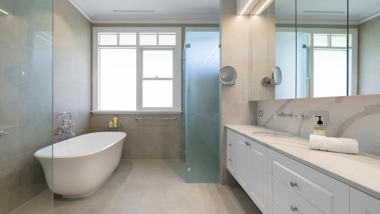 A bathtub, shower and plenty of storage in one of the bathrooms.