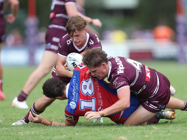 Dane Woolley and Charlie Woolf tackle Caleb McRae. Picture: Sue Graham