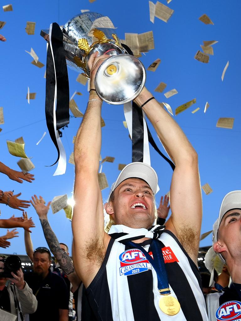 Darcy Moore and the premiership trophy. Photo by Quinn Rooney/Getty Images