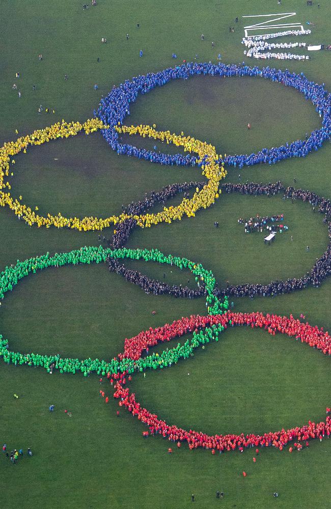 An aerial view thousands of people wearing colourful ponchos have formed the Olympic rings to support Hamburg's bid for the Olympics 2024, in a park in Hamburg.